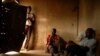 FILE - Illegal Zimbabwean immigrants who work as farm laborers are seen inside their room on a farm near the Beitbridge border post, between South Africa and Zimbabwe, in the Limpopo Province, in March 2006.