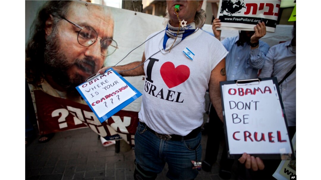 FILE - Israeli protesters hold posters demanding the release of Jonathan Pollard, a Jewish American who was jailed for life in 1987 on charges of spying on the United States, as they stand outside the U.S. Embassy in Tel Aviv, Israel, June 19, 2011.