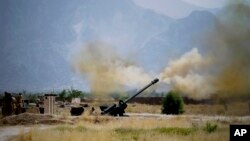 FILE - In this June 1, 2011, file photo, Pakistani troops fire heavy artillery toward alleged militants hideouts in mountain ranges along the Afghan border. 
