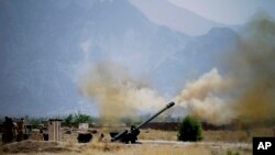 FILE - IN this June 1, 2011, file photo, Pakistani troops fire heavy artillery toward alleged militants hideouts in mountain ranges along the Afghan border. 