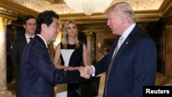 FILE - Japan's Prime Minister Shinzo Abe meets with then U.S. President-elect Donald Trump at Trump Tower in New York, Nov. 17, 2016.