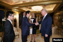 Japan's Prime Minister Shinzo Abe meets with U.S. President-elect Donald Trump (R) at Trump Tower in Manhattan, New York, Nov. 17, 2016.