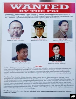 FILE: A poster of five Chinese military officers accused of stealing U.S. companies’ trade secrets is displayed at the Justice Department in Washington, D.C., on May 19, 2014.