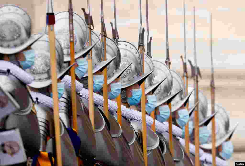 Members of the Pontifical Swiss Guard stand by at St. Peter&#39;s Square before Pope Francis delivers his traditional Christmas Day Urbi et Orbi speech to the city and the world from the main balcony of St. Peter&#39;s Basilica at the Vatican, Dec. 25, 2021.