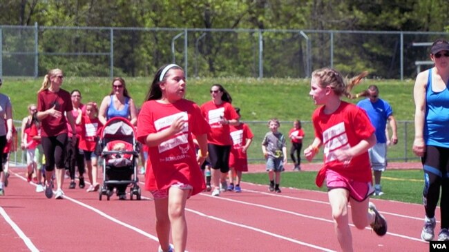 Students at Bermudian Springs school run on the track. The school is proud of its diversity, and staff members say they have worked successfully to integrate their minority students. (M. Kornely/VOA)