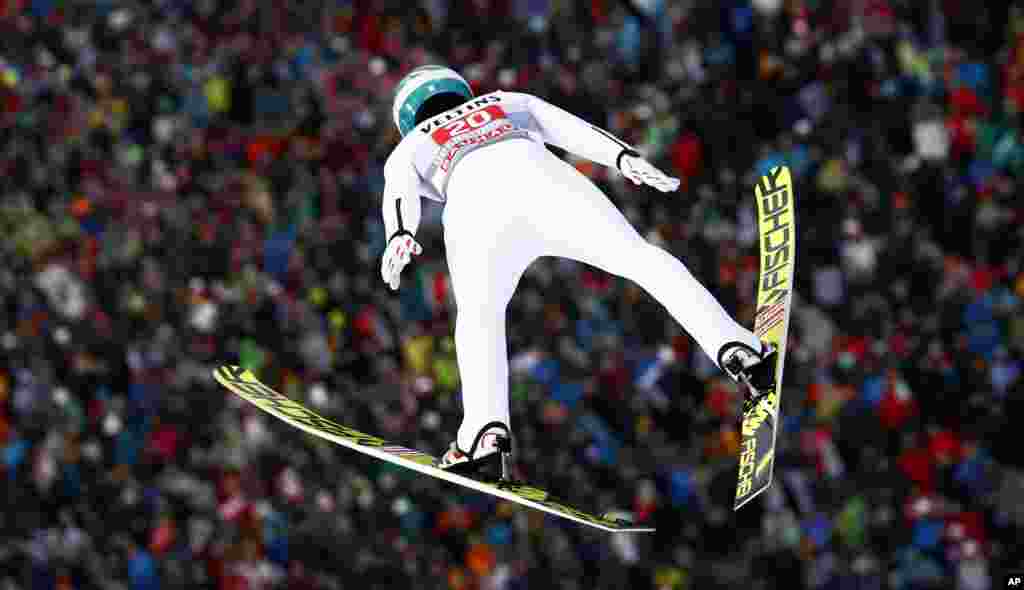 Austria&#39;s Michael Hayboeck soars through the air during a trial jump at the first stage of the 67th four hills ski jumping tournament in Oberstdorf, Germany.