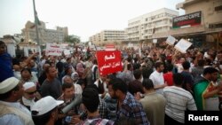 Pro-government protesters rally against gunmen who have taken control of two ministries in the capital, in front of the Libyan Prime Minister's residence, in Tripoli, Libya, May 3, 2013.