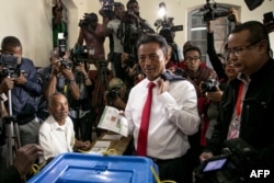 FILE - Malagasy Presidential Candidate Marc Ravalomanana casts his ballot at the polling station in Faravohitra district during the 2nd round of the presidential election, in Antananarivo, Dec. 19, 2018.