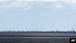 FILE - The alleged on-going reclamation of Subi Reef by China is seen from Pag-asa Island in the Spratly Islands in the South China Sea, western Palawan Province, Philippines, May 2015.