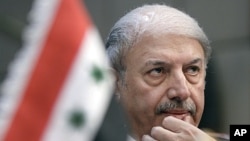Yussef Ahmed, Syria's ambassador to the Arab League, looks on during the body's emergency session on Syria at the Arab League headquarters in Cairo, Egypt, November 12, 2011.