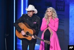 Hosts Brad Paisley, left, and Carrie Underwood appear at the 52nd annual CMA Awards at Bridgestone Arena, Nov. 14, 2018, in Nashville, Tenn.