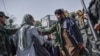 Taliban members stop women protesting for women's rights in Kabul on October 21, 2021. - The Taliban violently cracked down on media coverage of a women's rights protest in Kabul on October 21 morning, beating several journalists. (Photo by BULENT KILIC 