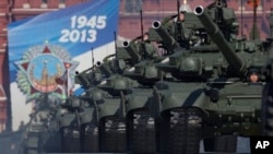 Russian tanks move along Red Square during a Victory Day parade, Moscow, May 9, 2013.