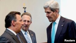 U.S. Secretary of State John Kerry (R) talks with Mexico's Foreign Minister Jose Antonio Meade, as U.S. Ambassador to Mexico E. Anthony Wayne (C) watches, before they participate in a joint bilateral forum on higher education, innovation and research, at the Ministry of Foreign Affairs in Mexico City, May 21, 2014. 