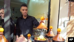 Tagines, or meat and vegetables stews, cook outside a restaurant in the medina of Marrakech.