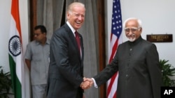 U.S. Vice President Joe Biden (L) shakes hands with Indian Vice President Hamid Ansari as they pose for the media before a meeting in New Delhi, India, July 23, 2013.