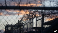 FILE - Dawn arrives at the now-closed Camp X-Ray at Guantanamo Bay Naval Base, Cuba, Nov. 21, 2013. A former al-Qaida militant who wrote a diary about life at Guantanamo Bay has been released from the detention center.