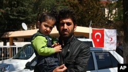Ciwan, who would only give his first name because he has family still in Syria, escaped with his son from his hometown Idlib, Yayladagi, Turkey, March 22 , 2012.