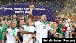 Soccer Football - Africa Cup of Nations 2019 - Final - Senegal v Algeria - Cairo International Algeria's Islam Slimani celebrates with the trophy and team mates after winning the Africa Cup of Nations REUTERS/Suhaib Salem - RC18789B7170