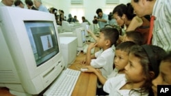 Visitors watch as Cambodian orphans learn computer skills and exploring the Internet world during the opening ceremony at the Future Light Orphanage on the outskirt of Phnom Penh, Cambodia, file photo. 