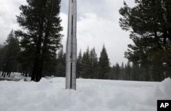 The snow survey tube sits in the snow placed there by Frank Gehrke, chief of the California Cooperative Snow Surveys Program for the Department of Water Resources, after conducting the manual snow survey at Phillips Station, March 30, 2017, near Echo Summit, Calif.