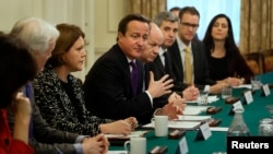 Britain's Prime Minister David Cameron (C) sits with Secretary of State for Culture Media and Sport, Maria Miller (3rd L) as he hosts an Internet safety summit at Number 10 Downing Street in London, Nov.18, 2013. 