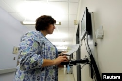 FILE - Geisinger Health System maternity ward nurse Nichole Madara enters and checks patient medical records in Geisinger's computerized health records system in Danville, Pennsylvania, Oct. 29, 2009.