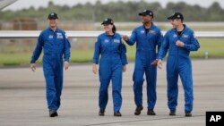 Astronaut Soichi Noguchi, of Japan, from left, NASA Astronauts Shannon Walker, Victor Glover and Michael Hopkins walk after arriving at Kennedy Space Center, Sunday, Nov. 8, 2020, in Cape Canaveral, Fla. 