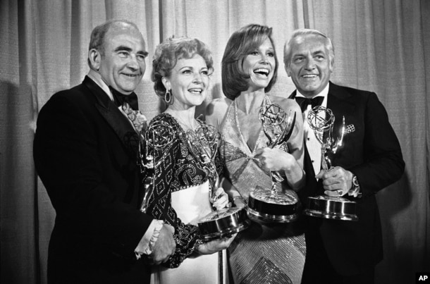 FILE - Members of "The Mary Tyler Moore Show" pose with their Emmys backstage at the 28th annual Emmy Awards in Los Angeles, May 18, 1976. From left are, Ed Asner, Betty White, Moore and Ted Knight.