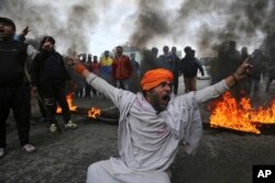 A protestor shouts slogans against Thursday's attack on a paramilitary convoy, in Jammu, India, Friday, Feb.15, 2019.