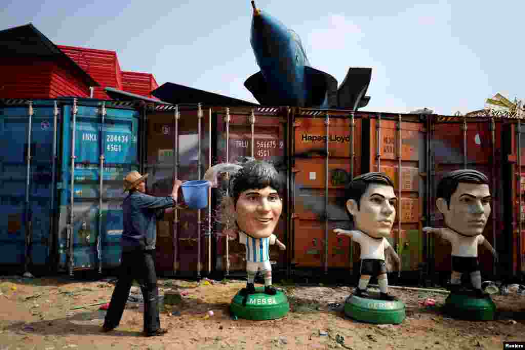 A worker cleans a Lionel Messi figure at a small factory oin the outskirts of Shanghai, China.