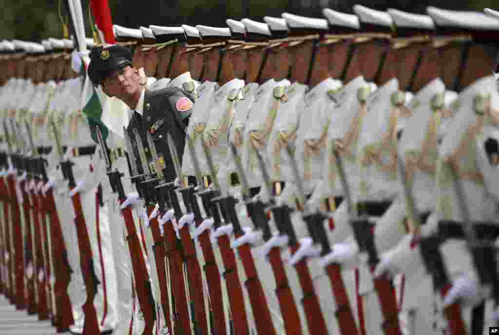 Japanese honor guard members prepare for inspection by Indian Defense Minister Arun Jaitley at the Defense Ministry in Tokyo.