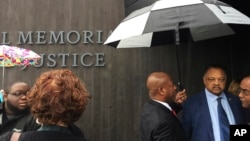 The Rev. Jesse Jackson, right, leaves an event at the National Memorial for Peace and Justice, a memorial to victims of lynching, in Montgomery, Ala., April 26, 2018. 