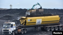 FILE - Heavy equipment is seen loading coal onto a truck at PT Adaro Indonesia coal mining in Tabalong, Kalimantan island, Indonesia Oct. 17, 2017.