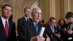 El líder de la mayoría del Senado, Mitch McConnell, republicano por Kentucky (centro) habla con periodistas sobre la posibilidad de un cierre parcial del gobierno. Dic. 18, 2018. 