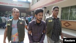 FILE - Police officers in Dhaka detain Nahid Hasan, a member of Jamaat-e-Islami, Bangladesh's biggest religion-based party, on suspicion he was involved in Islamic State propaganda, Nov. 25, 2015.