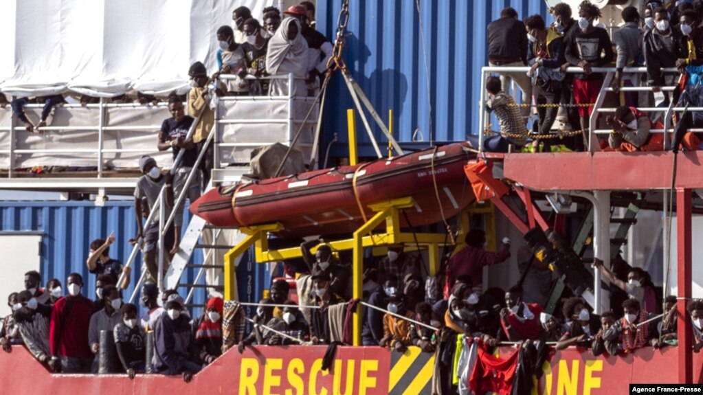 Migrants rescued in the Mediterranean sea arrive to disembark from the Sea-Eye 4 ship, Nov. 7, 2021, in the port of Trapani, Sicily, Italy. 