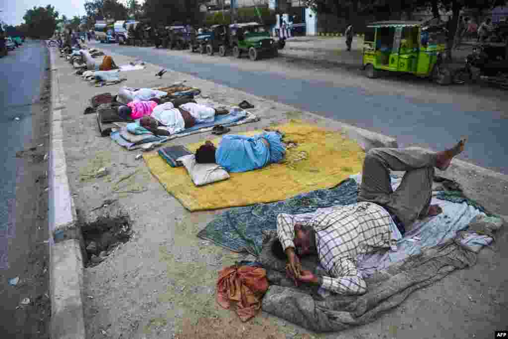 Laborers sleep on a median of a street in the port city of Karachi, Pakistan.