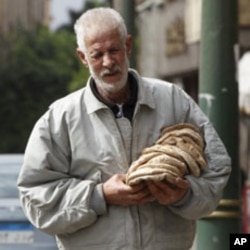 A man carries bread in Cairo on Feb. 6, 2011. Food prices continue to rise in Egypt.