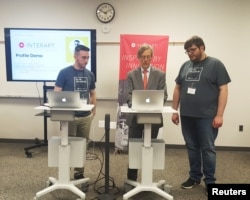 Co-director of the Appalachian Regional Commission Earl Gohl, center, is participating in a coding demo with Interapt trainees in Paintsville, Kentucky, March 13, 2017.