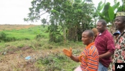 Community leaders in Nimba Point in Grand Cape Mount, Liberia, take Alfred Brownell (center) of Green Advocates, a member of the Rights and Resources Initiative, on a tour of land that had been cleared by Sime Darby, a Malaysia-based company.