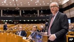 EU Commission President Jean Claude Juncker, left, addresses Members of European Parliament on Brexit during a plenary session at the European Parliament in Brussels on Jan. 30, 2019. 