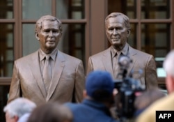 Statues of former Presidents George W. Bush (L) and his father George H.W. Bush are on display during a tour of the George W. Bush Presidential Center on the campus of Southern Methodist University in Dallas, Texas, Apr. 24, 2013.