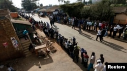 Kenyans wait to cast their vote at a polling station in Kibera.