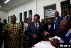 DRC President Joseph Kabila smiles as he arrives to vote at a polling station in Kinshasa, Democratic Republic of Congo, Dec. 30, 2018.