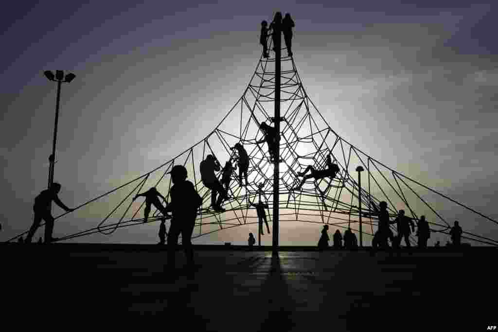 Children play at a playground on the Israeli coastal city of Tel Aviv.