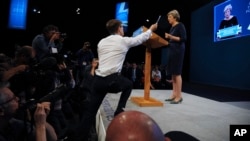 Comedian Simon Brodkin, also known as Lee Nelson, interrupts the Conservative Party Leader and Prime Minister, Theresa May, during her speech at the Conservative Party Conference at Manchester Central, in Manchester, England, Oct. 4, 2017.