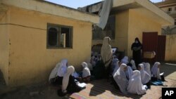 FILE - in this Wednesday, Oct. 7, 2020, students attend an open air class at a primary school in Kabul, Afghanistan. An Afghan education ministry memo banning girls from singing at public school functions received a lot of attention recently. (AP Photo/Mariam Zuhaib, File)
