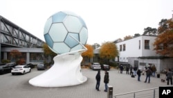 Media wait outside the headquarters of the German soccer federation DFB in Frankfurt, Germany, Nov. 3, 2015. 
