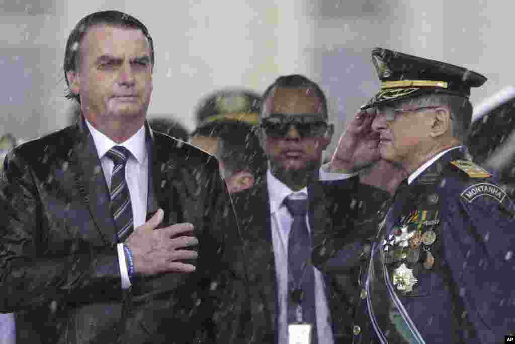 Brazil&#39;s President Jair Bolsonaro puts his hand over his heart while the national song plays in Brasilia, Brazil, on April 17, 2019. (AP Photo/Eraldo Peres)